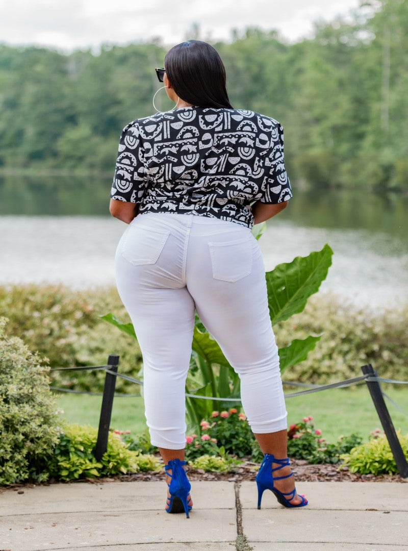 The Xi Encoded is a plus size top that packs all the features, a solid black body with a textured tribal print and a bronzed button detail as a bonus. This piece can be worn in several ways and photographs amazingly.