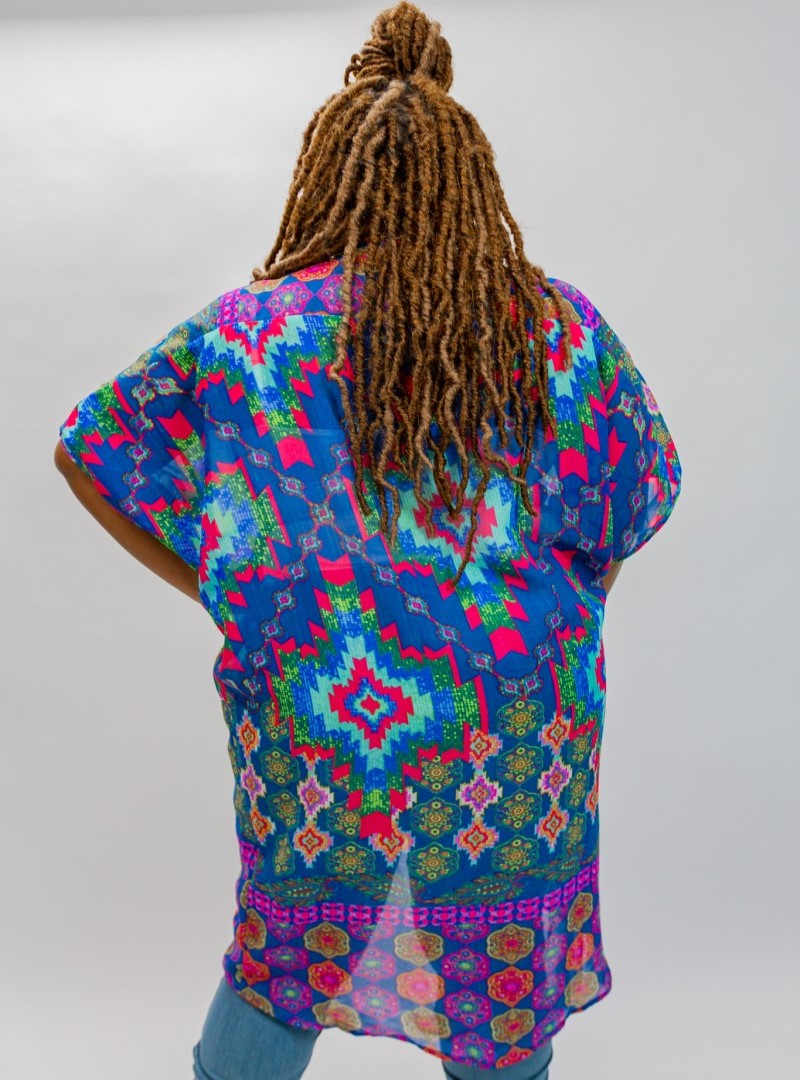 Our 'Native Chic Kimono" displays a bright and colorful Aztec design on a sheer solid. This kimono features a hi-lo pattern with open front panels.