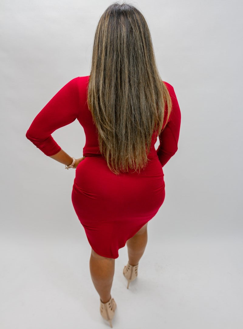 The Don't Be Shy dress features a wrapped knot that stretches across the front. The fabric feels soft against the skin as it hugs your curves. Shop now, limited quantities in stock.