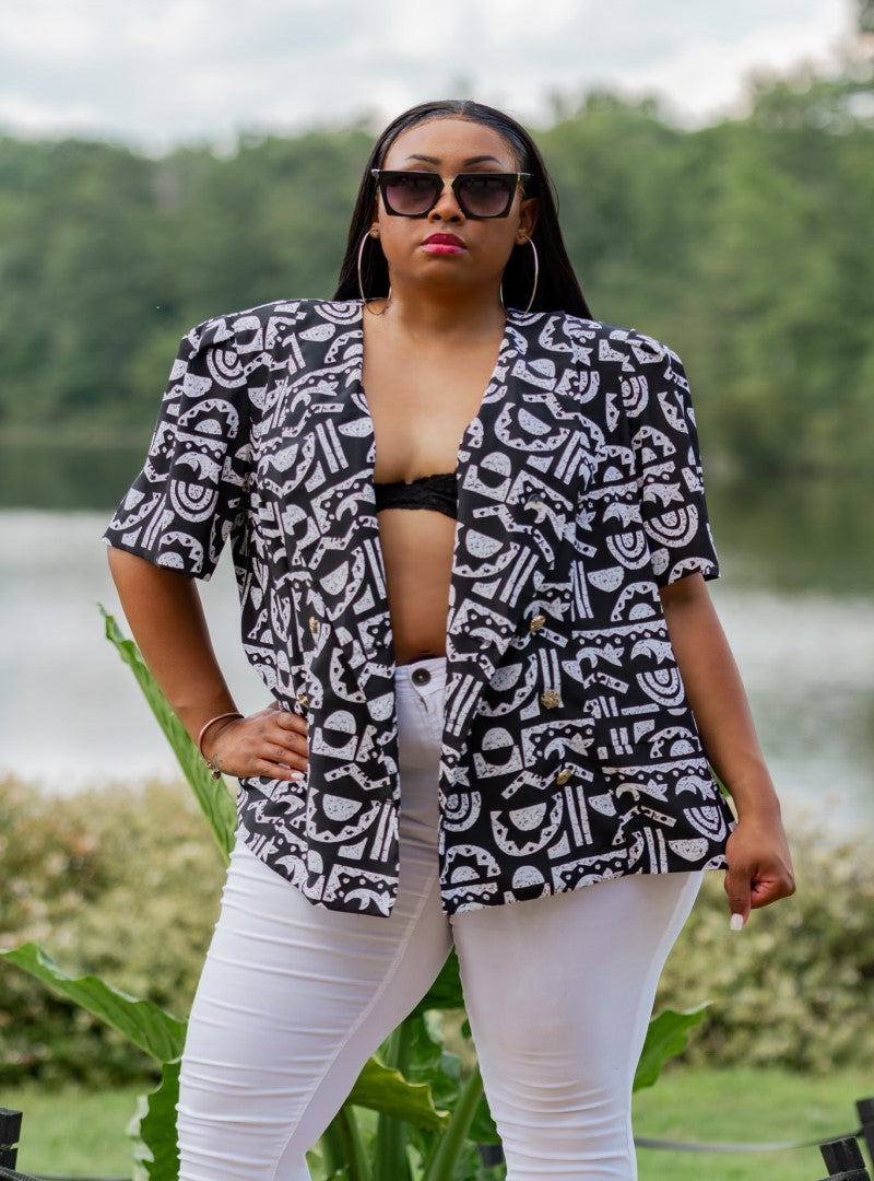  The Xi Encoded is a plus size top that packs all the features, a solid black body with a textured tribal print and a bronzed button detail as a bonus. This piece can be worn in several ways and photographs amazingly.