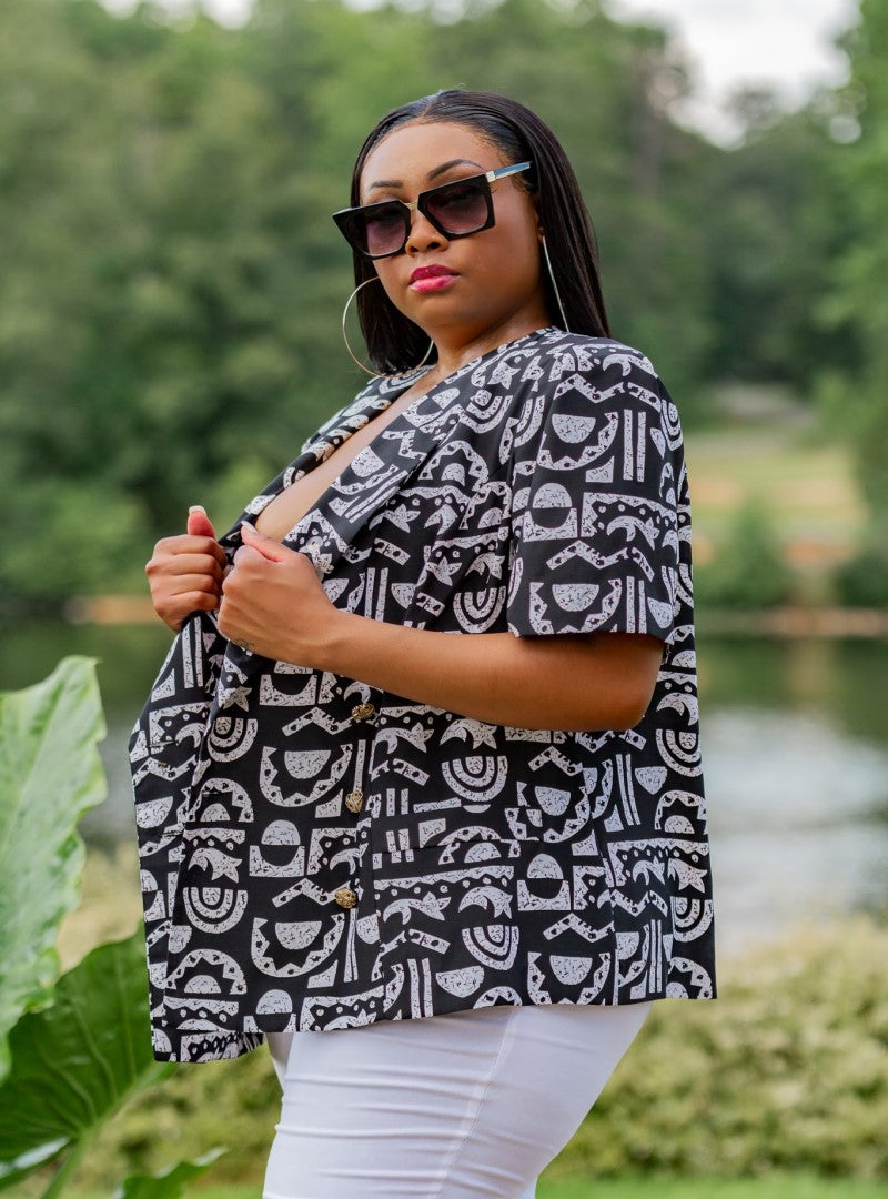  The Xi Encoded is a plus size top that packs all the features, a solid black body with a textured tribal print and a bronzed button detail as a bonus. This piece can be worn in several ways and photographs amazingly.